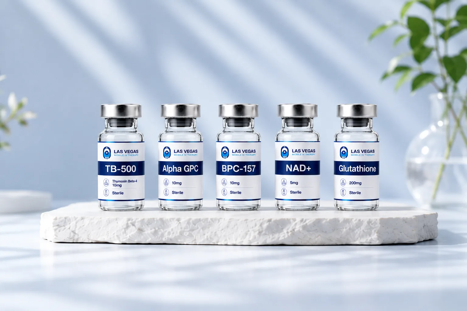 Las Vegas Mobile IV Therapy peptide vials lined up on a stone plinth: TB-500, Alpha GPC, BPC-157, NAD+ and Glutathione